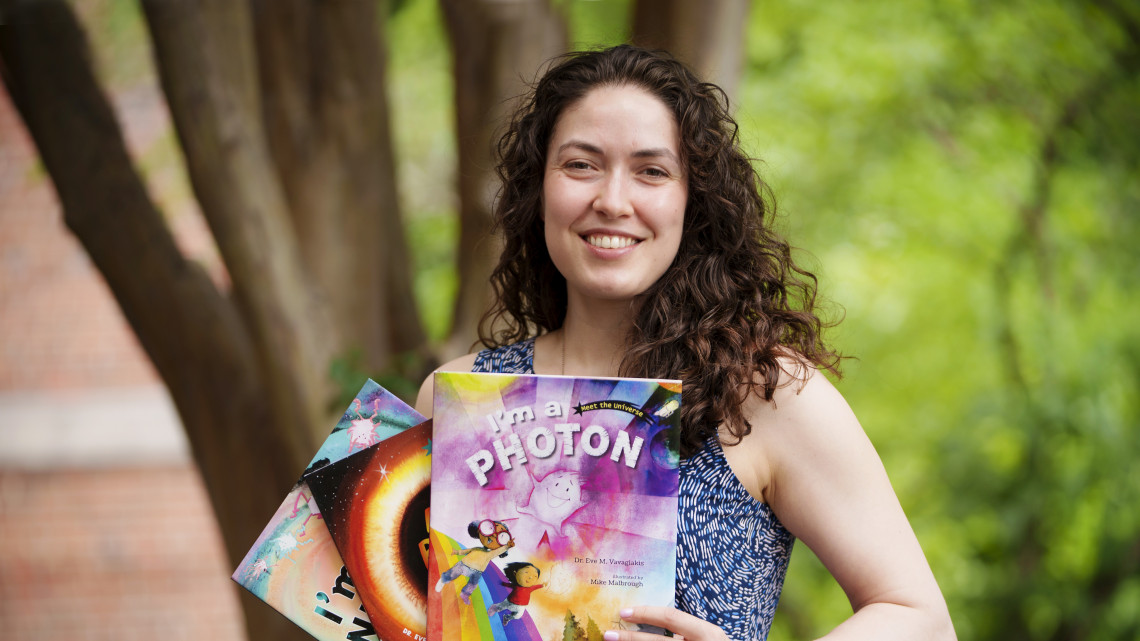 Eve Vavagiakis holding three children's books she has written