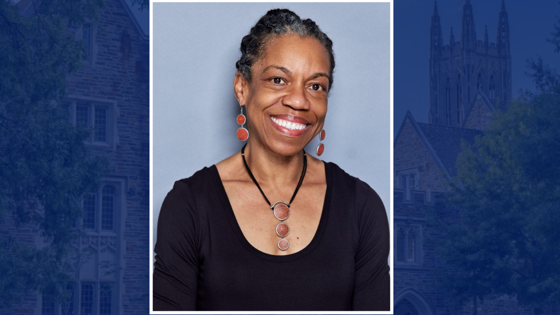 Headshot of Charmaine Royal on a decorative Duke background.