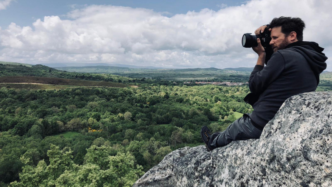 Edward Triplett taking photos while hiking in mountains