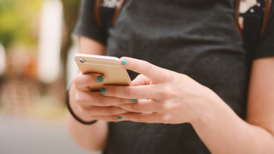 close up image of hands holding a cell phone