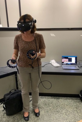 Professor Laura Michetti standing using VR