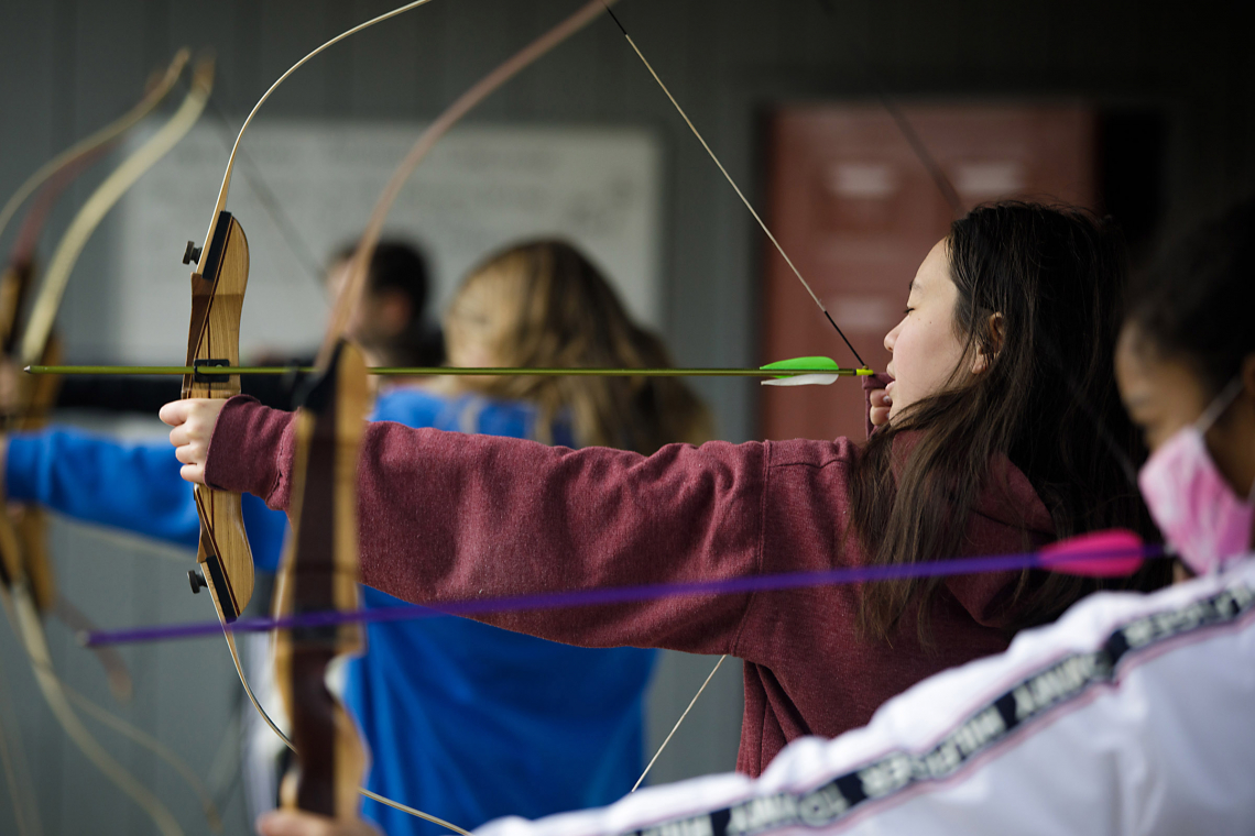 Transformative Ideas students practice archery during weekend retreat 
