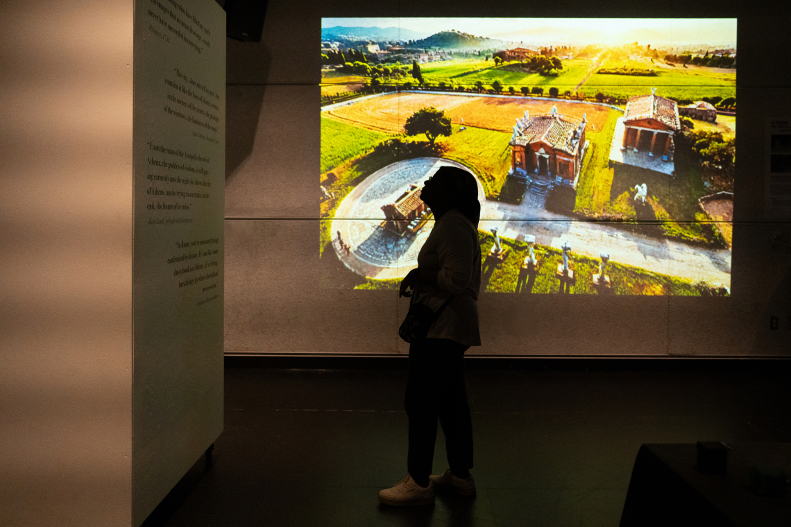 student looking at Antiquity and AI exhibit