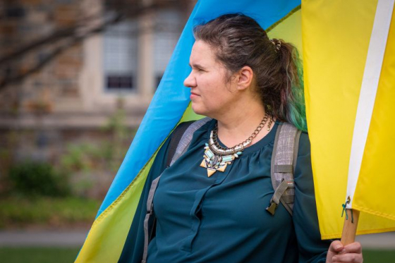 woman wrapped in Ukrainian flag