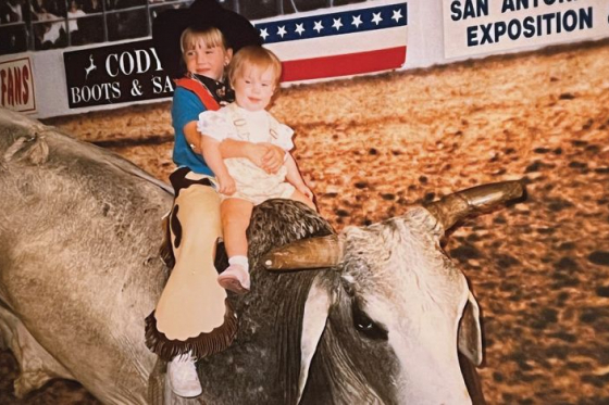 Growing up outside of Houston, Amanda Hargrove, shown here posing with her younger sister on a stuffed bull, was able to enjoy plenty of quintessentially Texan experiences as a kid. Photo courtesy of Amanda Hargrove.