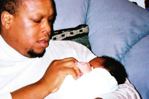 Mark Anthony Neal holds his baby daughter