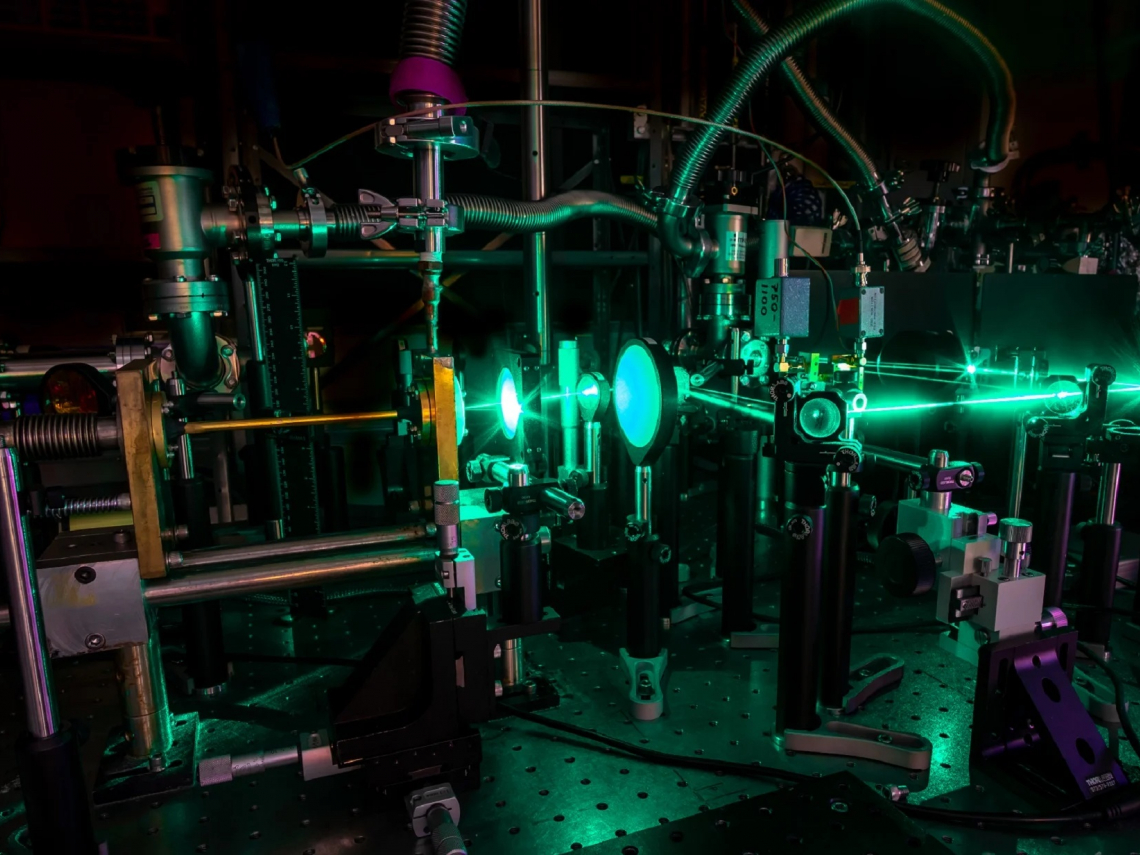A complicated device shooting a green laser