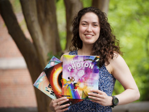 Eve Vavagiakis holding three children's books she has written