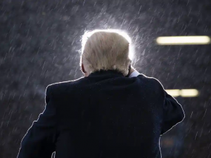 Donald Trump in the rain, photographed from behind