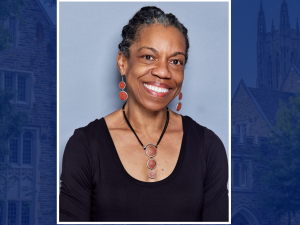 Headshot of Charmaine Royal on a decorative Duke background.