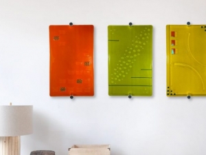 3 pieces of glass artwork hanging on a wall