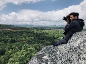 Edward Triplett taking photos while hiking in mountains