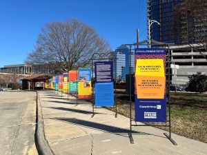 banners for "Our History, Our Voice: Latinés at Duke" exhibit line the sidewalk leading to Museum of Durham History