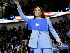 Kamala Harris waving to crowd, with video play button on screen