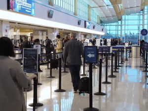 people waiting in security line at an airport