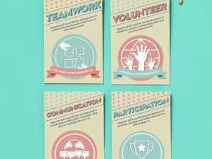 posters reading "Teamwork," "Volunteer," "Communication," "Participation"