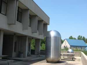 A metal cylinder outside of a building