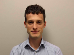 Alexander Volfovsky stares at the camera, arms crossed