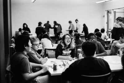 A black and white photo of students around a table playing a game