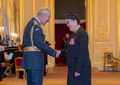King Charles III presents Duke faculty Terrie Moffitt with the title “Member of the Most Excellent Order of the British Empire”