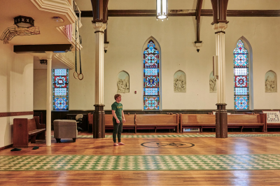 A man stands in an old church converted into a gym