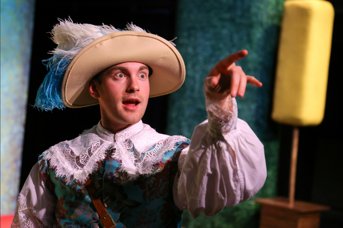 student in the liar production on stage