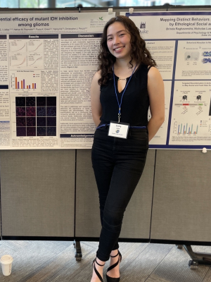 Woman posing in front of poster presentation